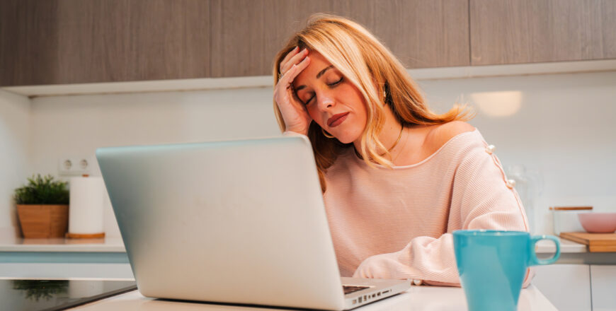 a hard working woman, desperate due to laptop issues causing her stress and headaches.