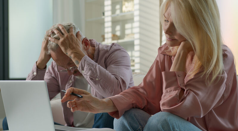 Worried senior caucasian married couple man woman checking bills bank loan payment learn documents discuss unpaid debt