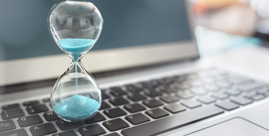 hourglass on laptop computer concept for time management and countdown to deadline